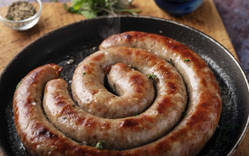 Traditional Danish Medister sausage been fried in a pan. Very pork heavy sausage with added fat, lard or suet, chopped onion, allspice, cloves, salt and pepper. The sausage is cooked in 1 or 2 long pieces then chopped into smaller portions at the dinner table. Traditionally eaten with boiled potatoes, red cabbage and remoulade. Please look for my other pictures in this series. Colour, horizontal with some copy space.